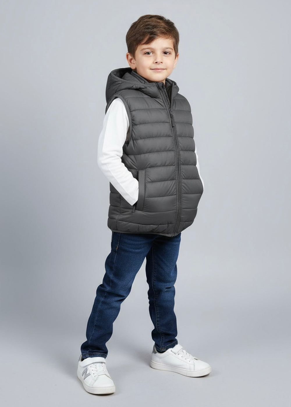Child wearing a charcoal sleeveless puffer jacket with hoodie