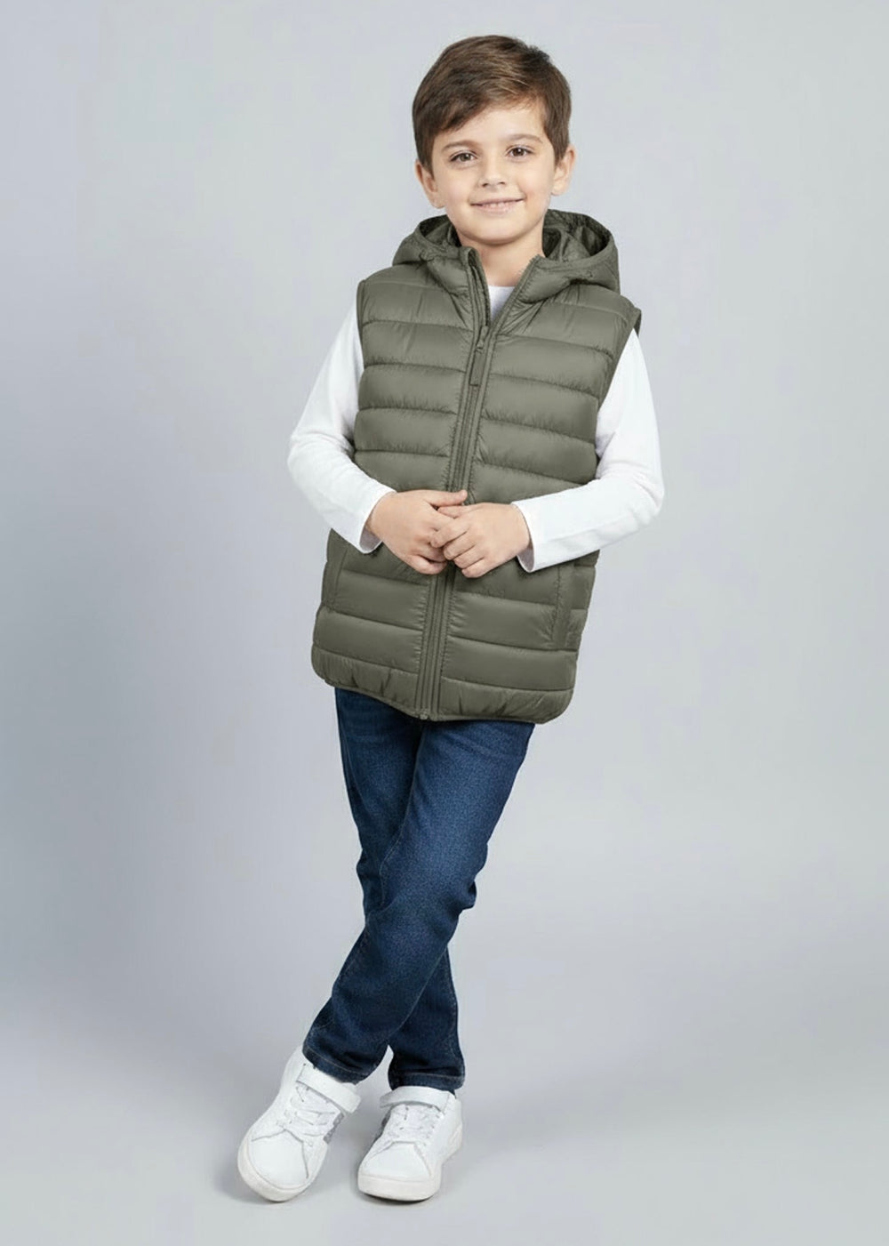 Child wearing a green sleeveless puffer jacket with hoodie