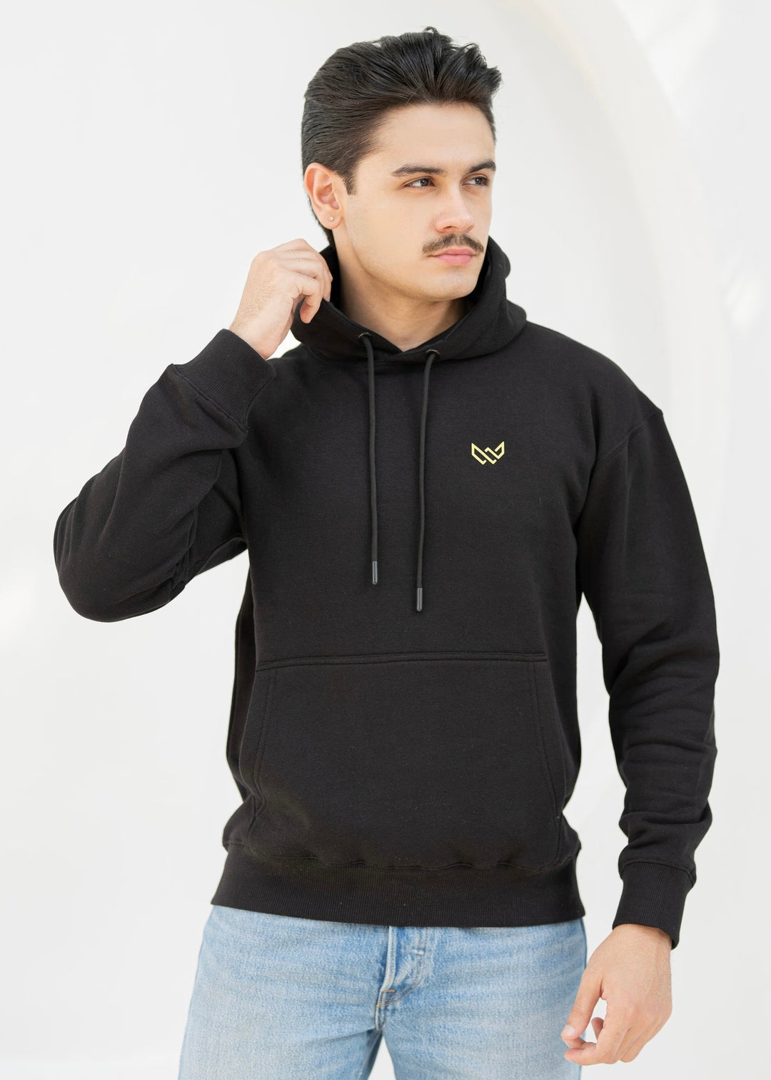 Man wearing a black hoodie with a logo on a white background