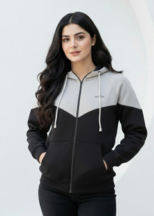 Woman wearing a black and gray hoodie with a white background