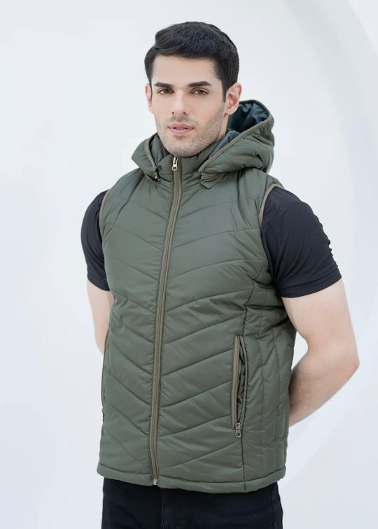 Man wearing a green quilted vest with removable hood